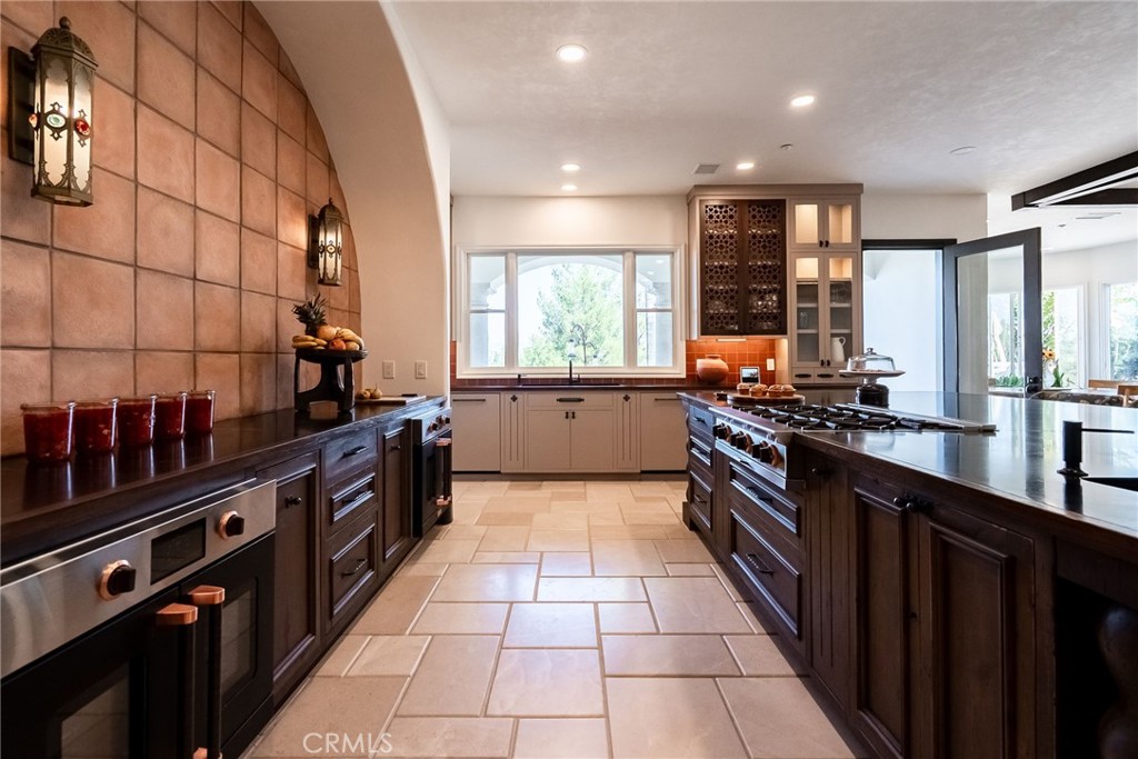 2019 Polo Court Riverside, CA 92506 - Photo 24 of 75 a kitchen with stainless steel appliances a sink stove and cabinets