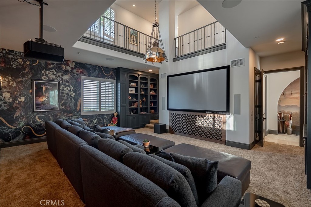 2019 Polo Court Riverside, CA 92506 - Photo 27 of 75 a living room with furniture a flat screen tv and a chandelier