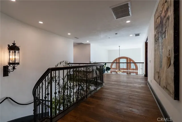 a bedroom with a bed a couch and a large window