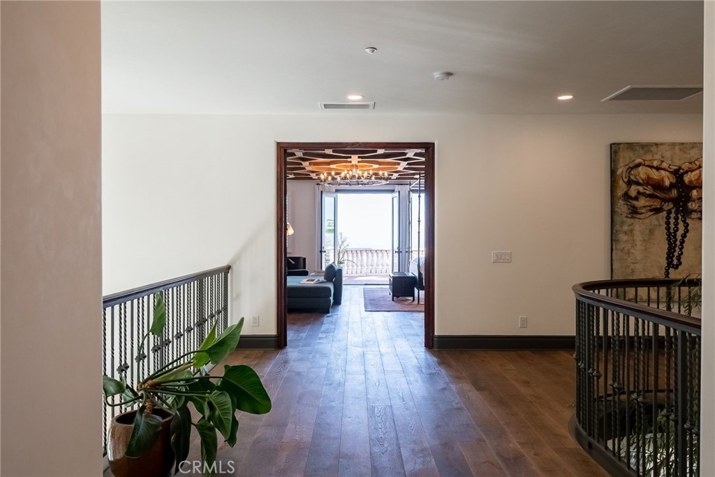 2019 Polo Court Riverside, CA 92506 - Photo 30 of 75 a hallway with wooden floor and a flower pot