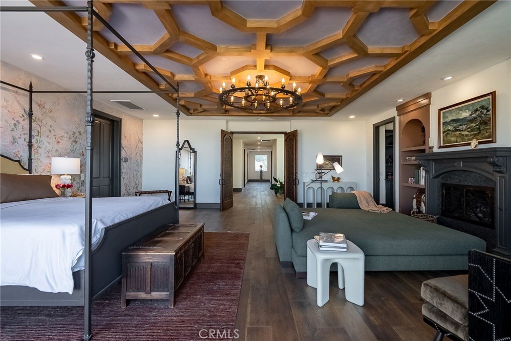 2019 Polo Court Riverside, CA 92506 - Photo 34 of 75 a dining room with wooden floor a chandelier a wooden table and chairs