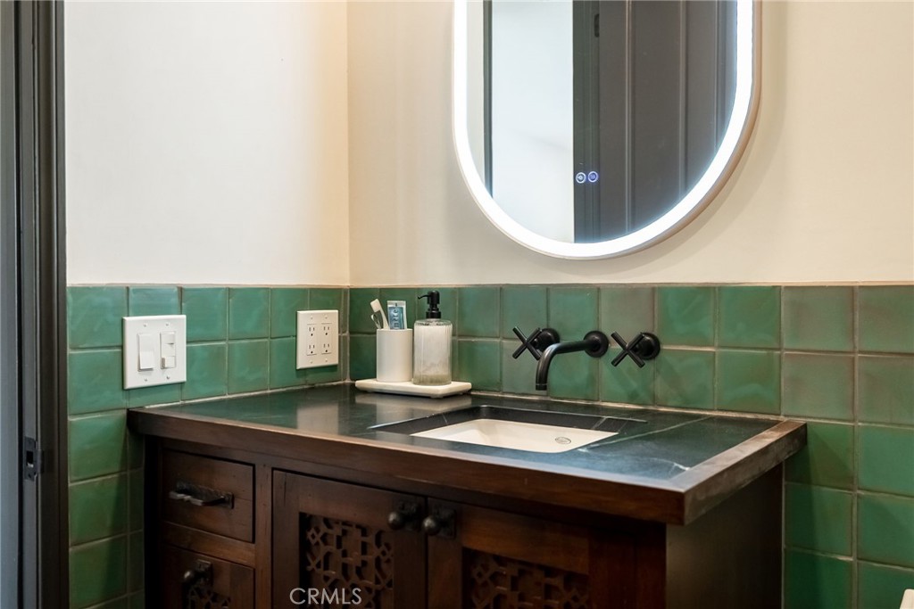 2019 Polo Court Riverside, CA 92506 - Photo 40 of 75 a bathroom with a sink and a mirror