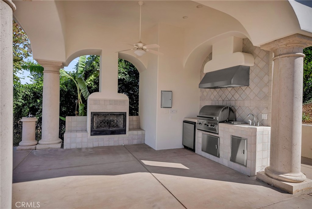 2019 Polo Court Riverside, CA 92506 - Photo 71 of 75 a kitchen with stainless steel appliances kitchen island a stove a refrigerator and a fireplace