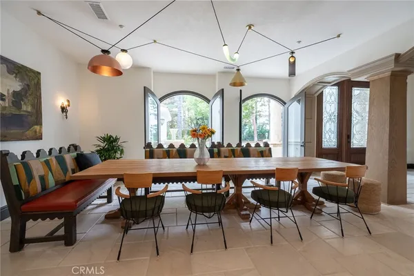 a living room with furniture a wooden floor and potted plant