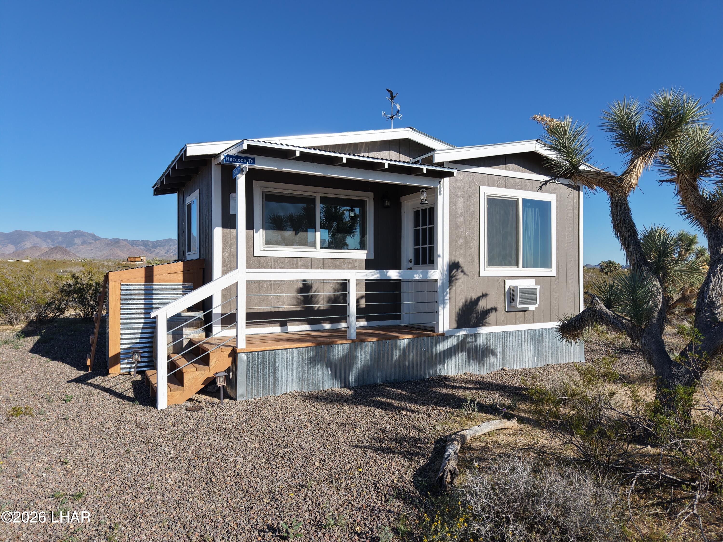 127 South Carrow Road Yucca, AZ 86438 - Photo 1 of 39 a view of a house with backyard and sitting area