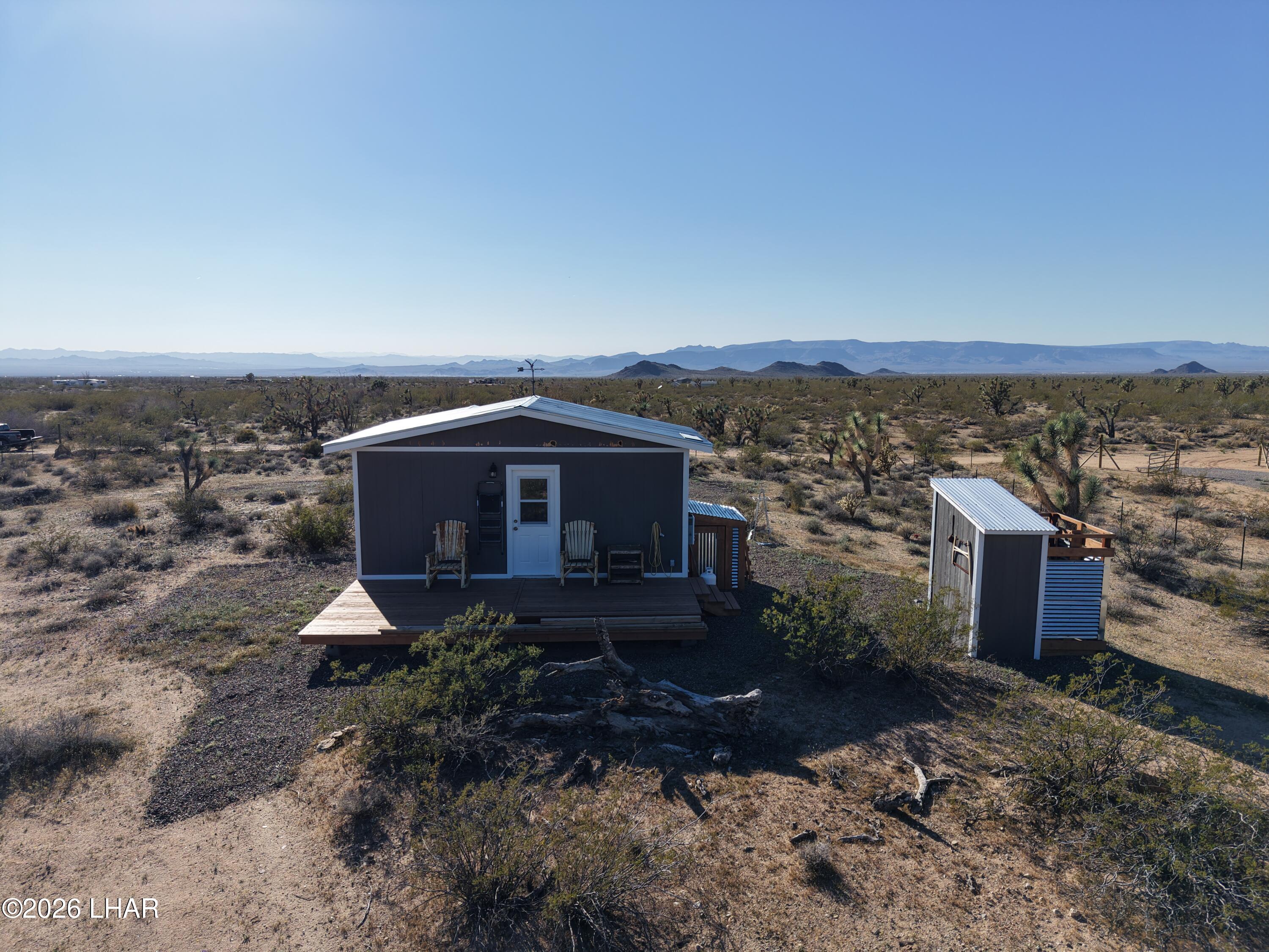 127 South Carrow Road Yucca, AZ 86438 - Photo 11 of 39 a front view of a house with a yard