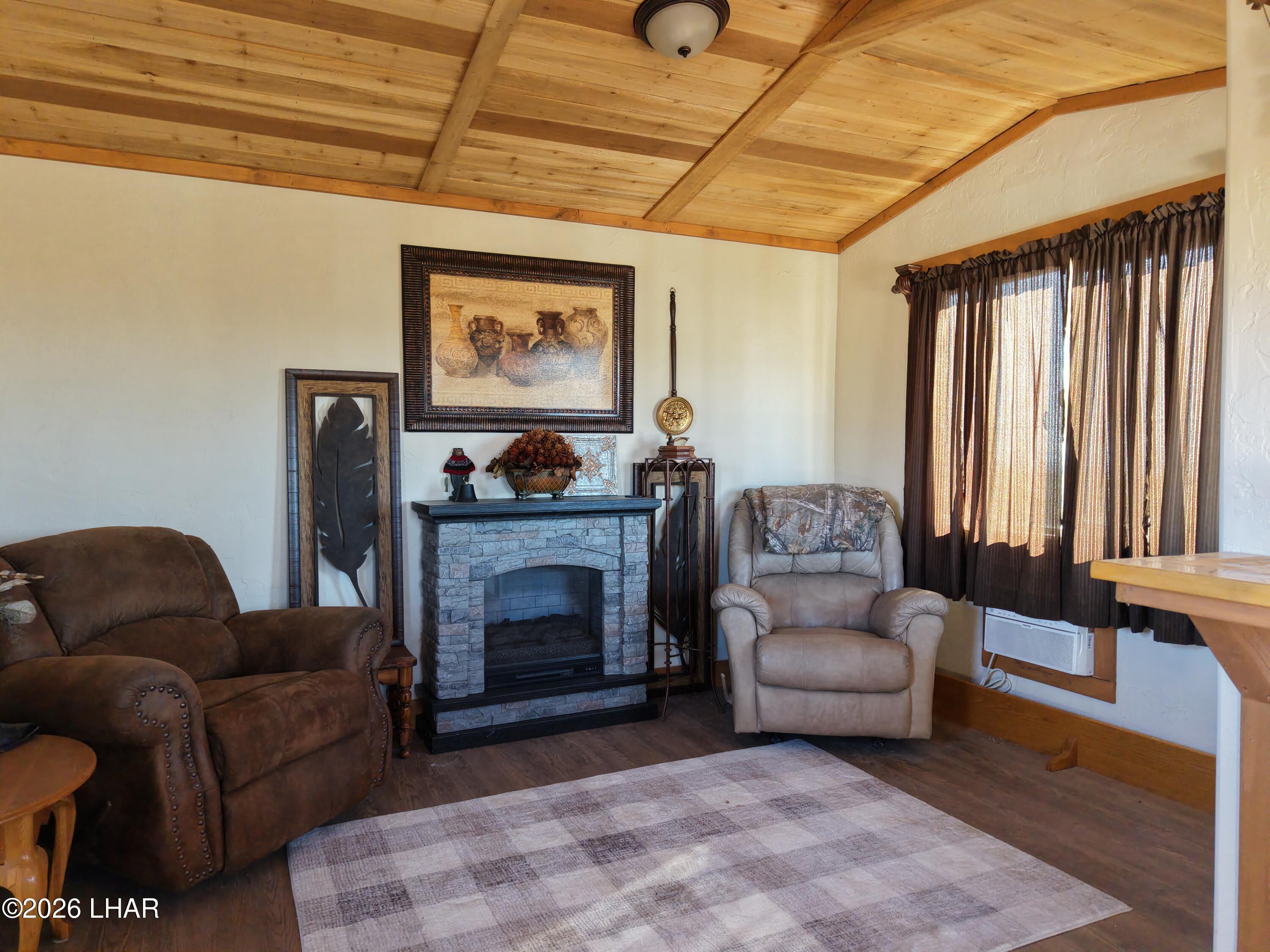 127 South Carrow Road Yucca, AZ 86438 - Photo 17 of 39 a living room with furniture and a fireplace