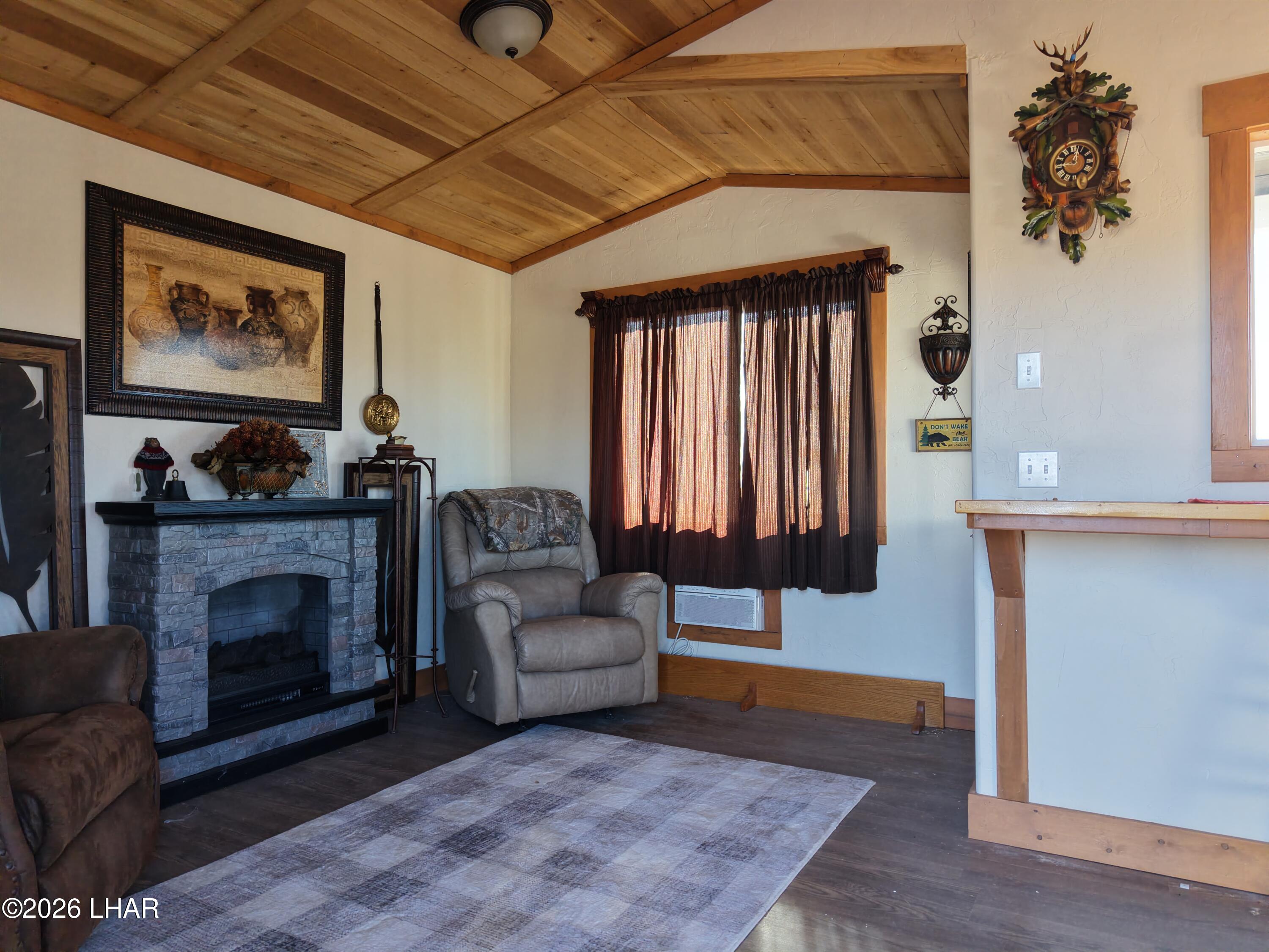 127 South Carrow Road Yucca, AZ 86438 - Photo 18 of 39 a living room with furniture and a fireplace