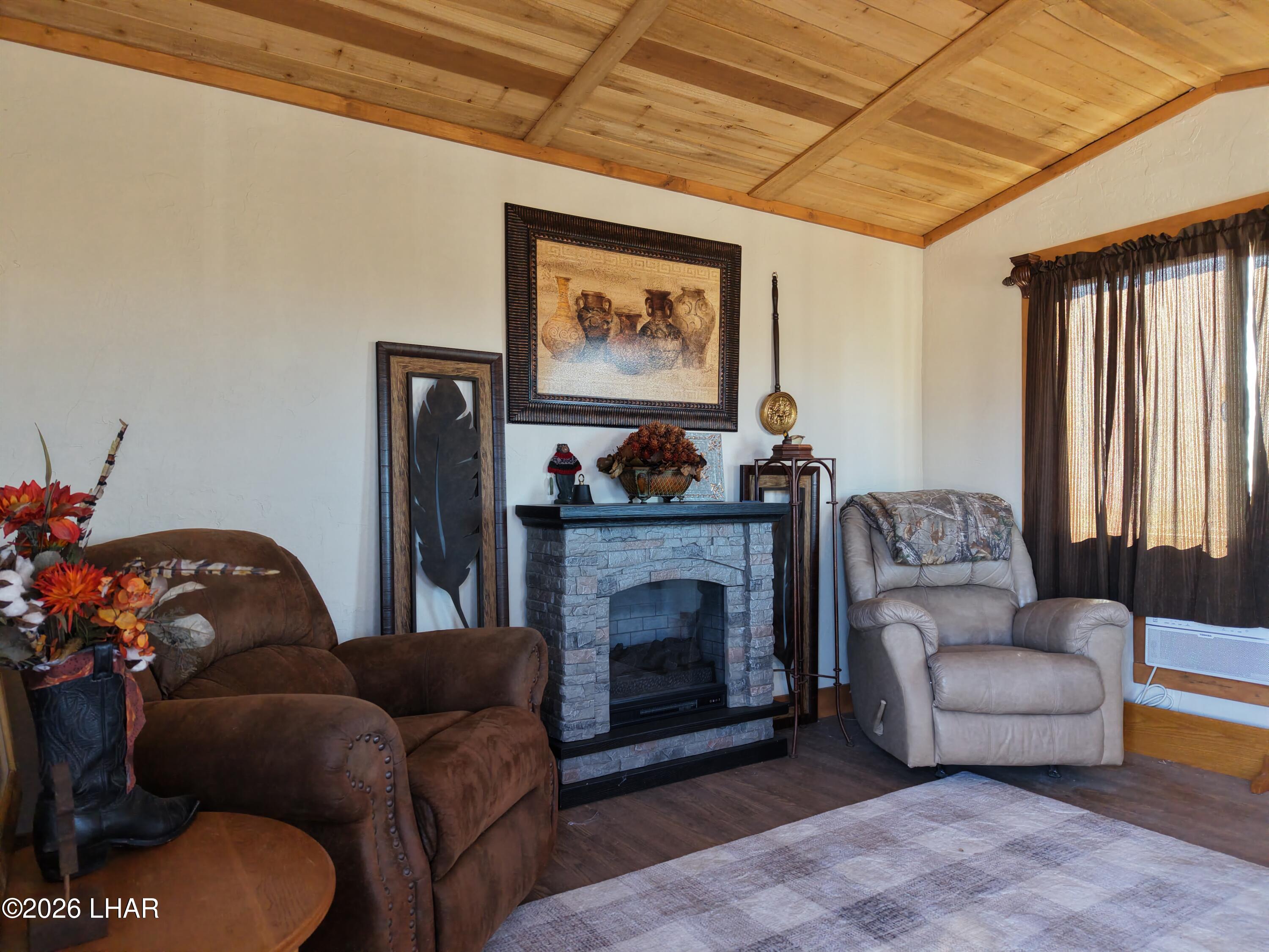 127 South Carrow Road Yucca, AZ 86438 - Photo 2 of 39 a living room with furniture a fireplace and a large window