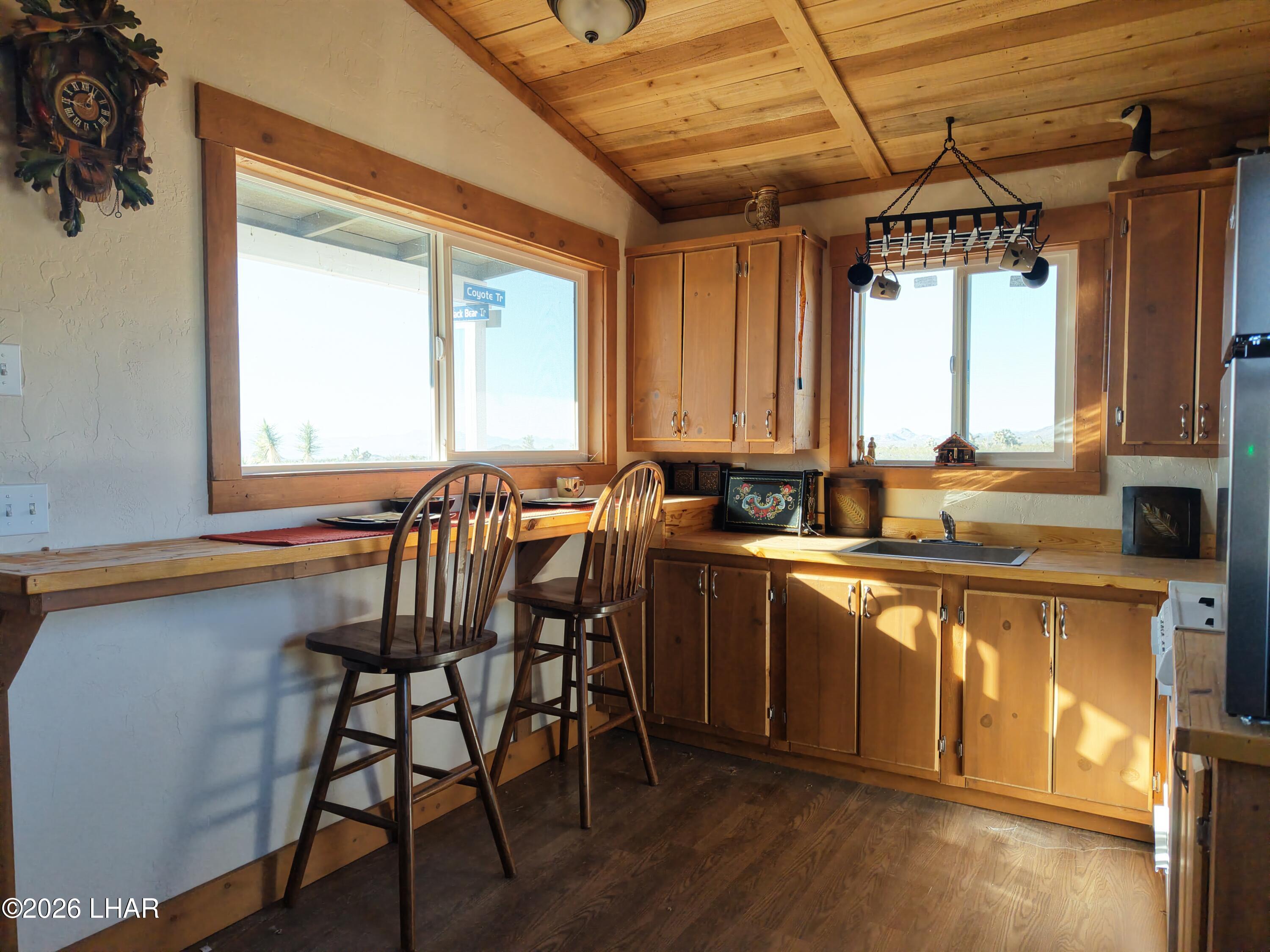 127 South Carrow Road Yucca, AZ 86438 - Photo 21 of 39 a kitchen with a table chairs sink and cabinets