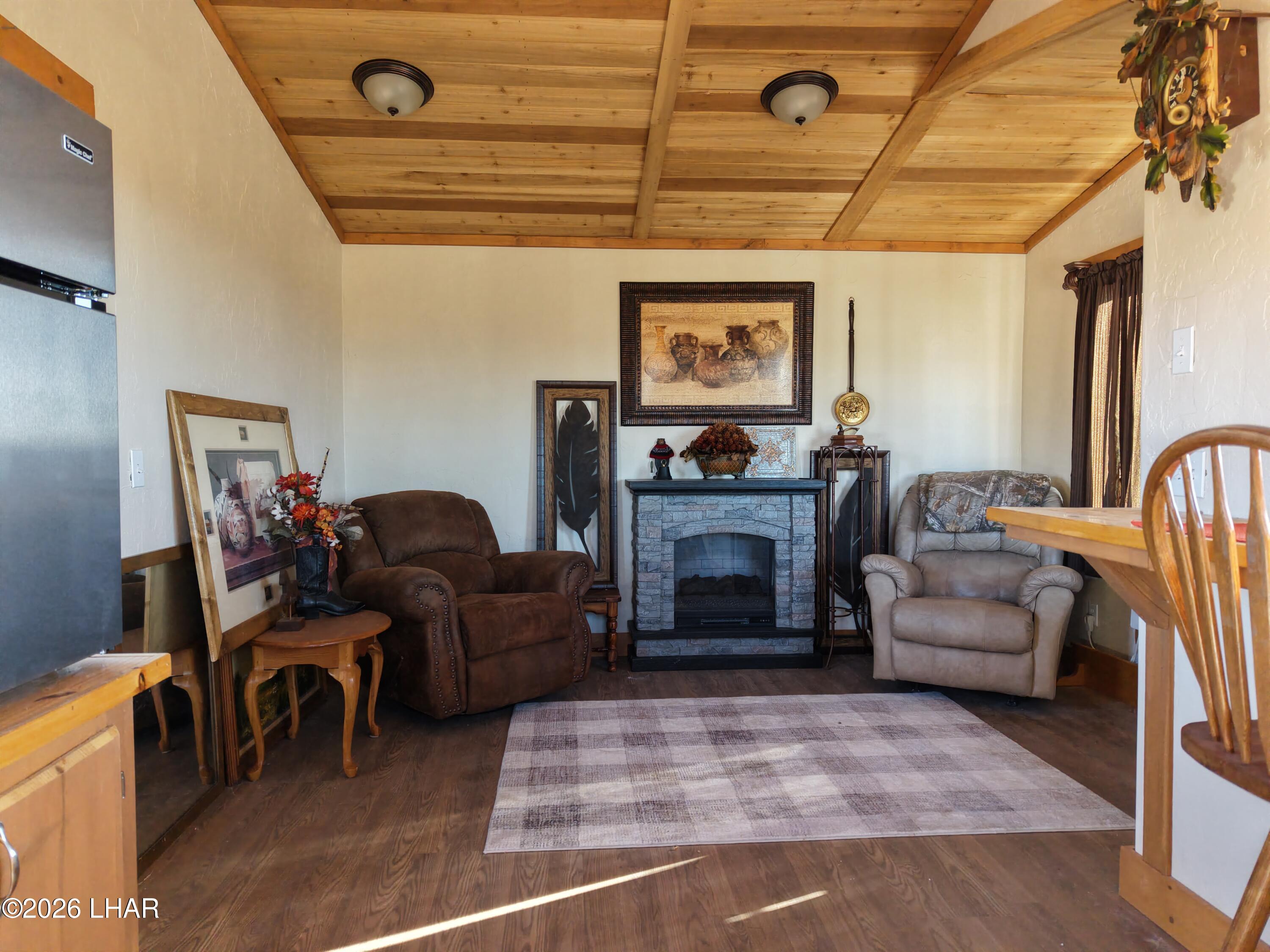 127 South Carrow Road Yucca, AZ 86438 - Photo 24 of 39 a living room with furniture and a fireplace
