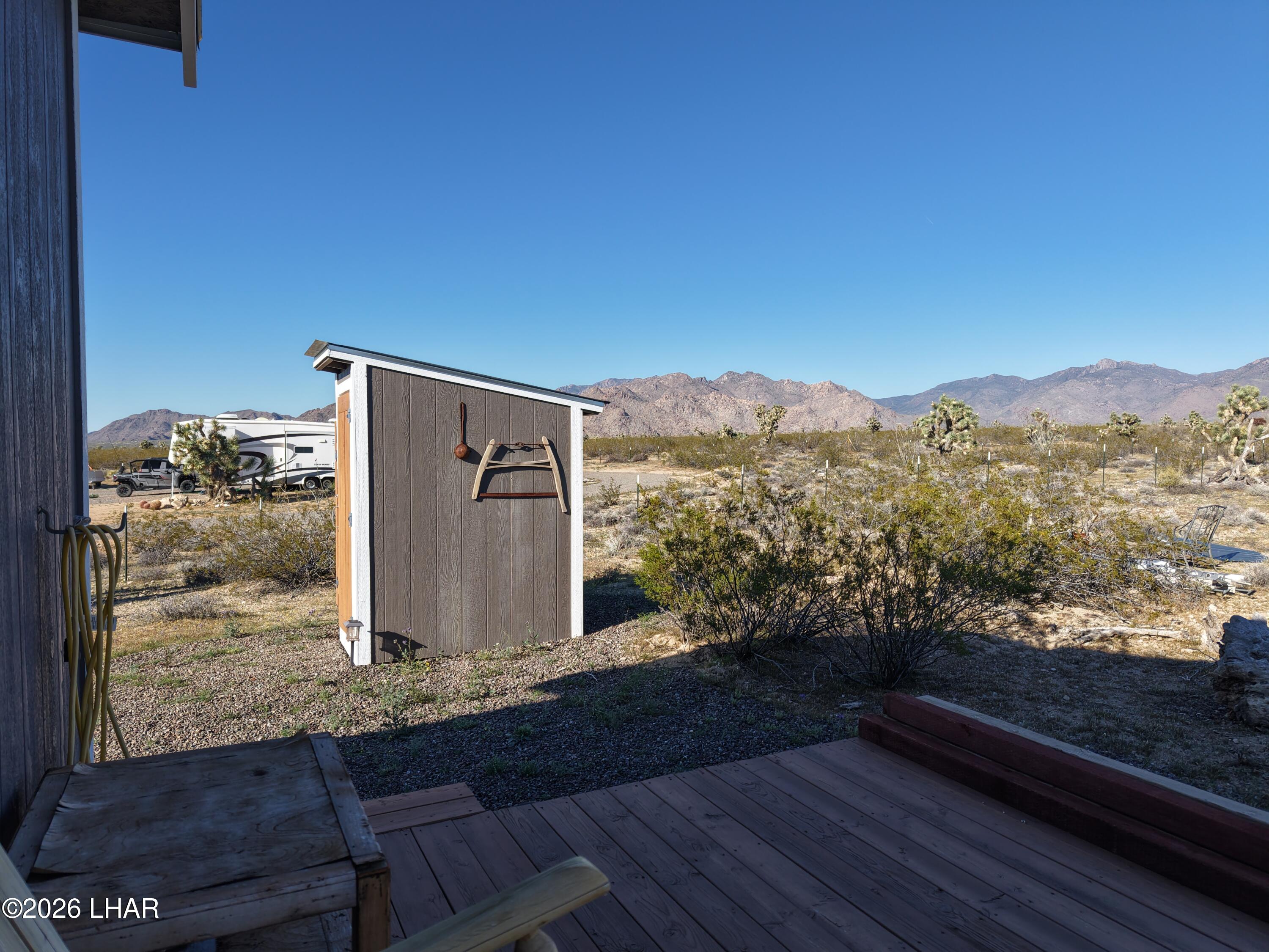127 South Carrow Road Yucca, AZ 86438 - Photo 25 of 39 a view of a house with mountain view and wooden floor