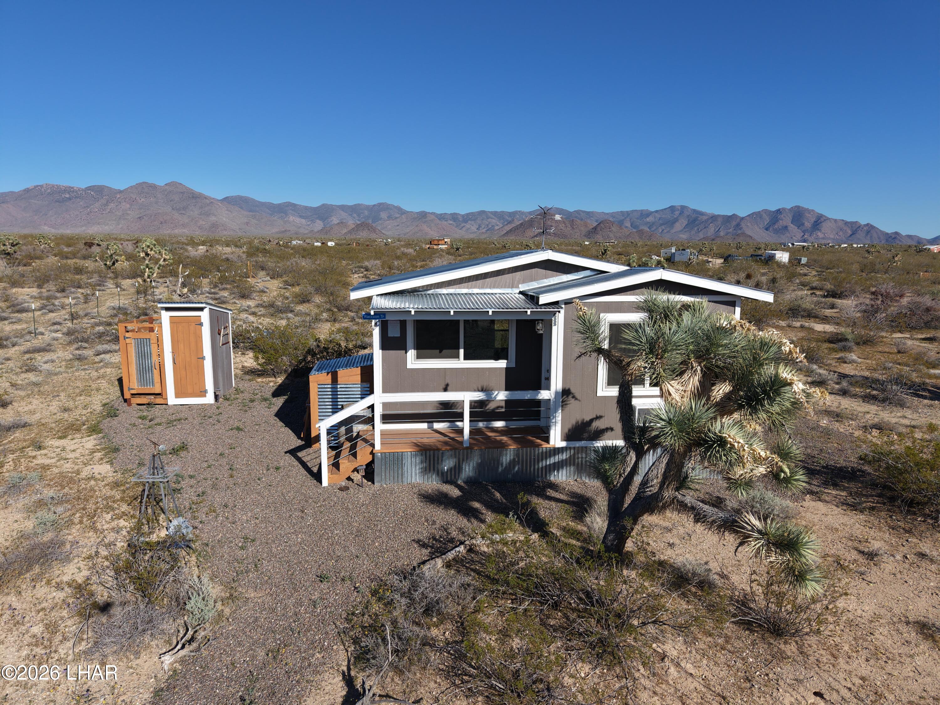 127 South Carrow Road Yucca, AZ 86438 - Photo 3 of 39 a view of a house with backyard and sitting area