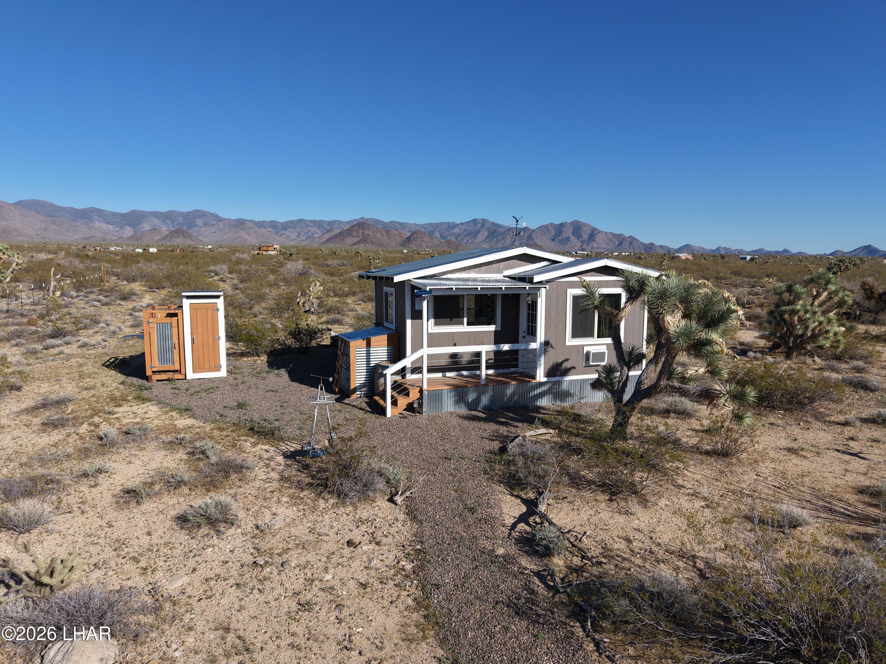 127 South Carrow Road Yucca, AZ 86438 - Photo 4 of 39 a view of a house with a yard and sitting area
