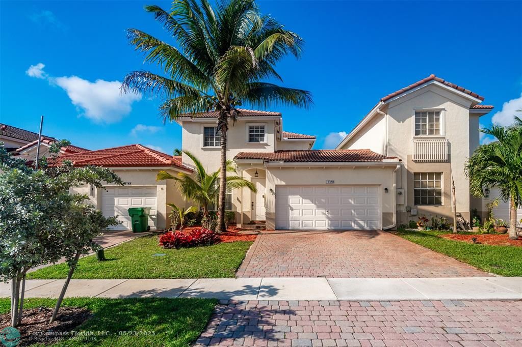 18798 Southwest 28th Street, Unit 18798 Miramar, FL 33029 - Photo 1 of 28 a front view of a house with a yard and garage