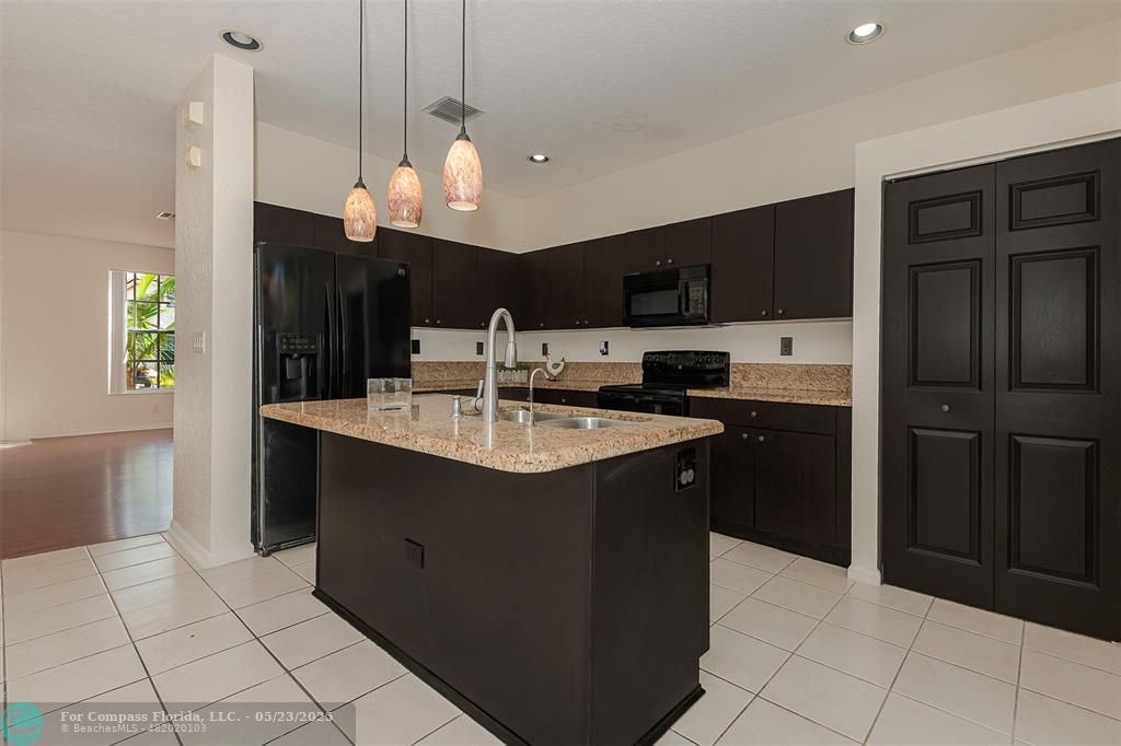 18798 Southwest 28th Street, Unit 18798 Miramar, FL 33029 - Photo 11 of 28 a kitchen with stainless steel appliances granite countertop a refrigerator a sink and a oven