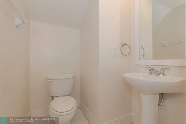 a white toilet sitting next to a bathroom sink