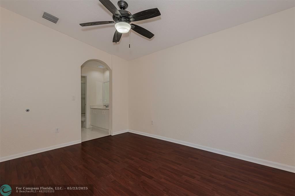 18798 Southwest 28th Street, Unit 18798 Miramar, FL 33029 - Photo 16 of 28 an empty room with wooden floor ceiling fan and window
