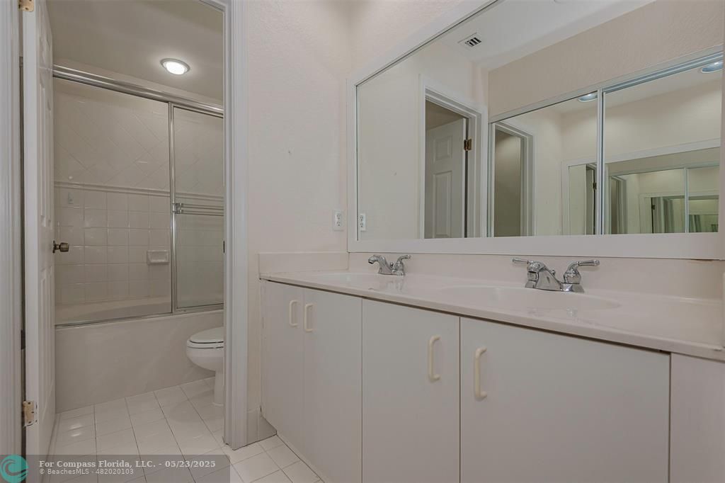 18798 Southwest 28th Street, Unit 18798 Miramar, FL 33029 - Photo 17 of 28 a bathroom with a double vanity sink mirror and toilet