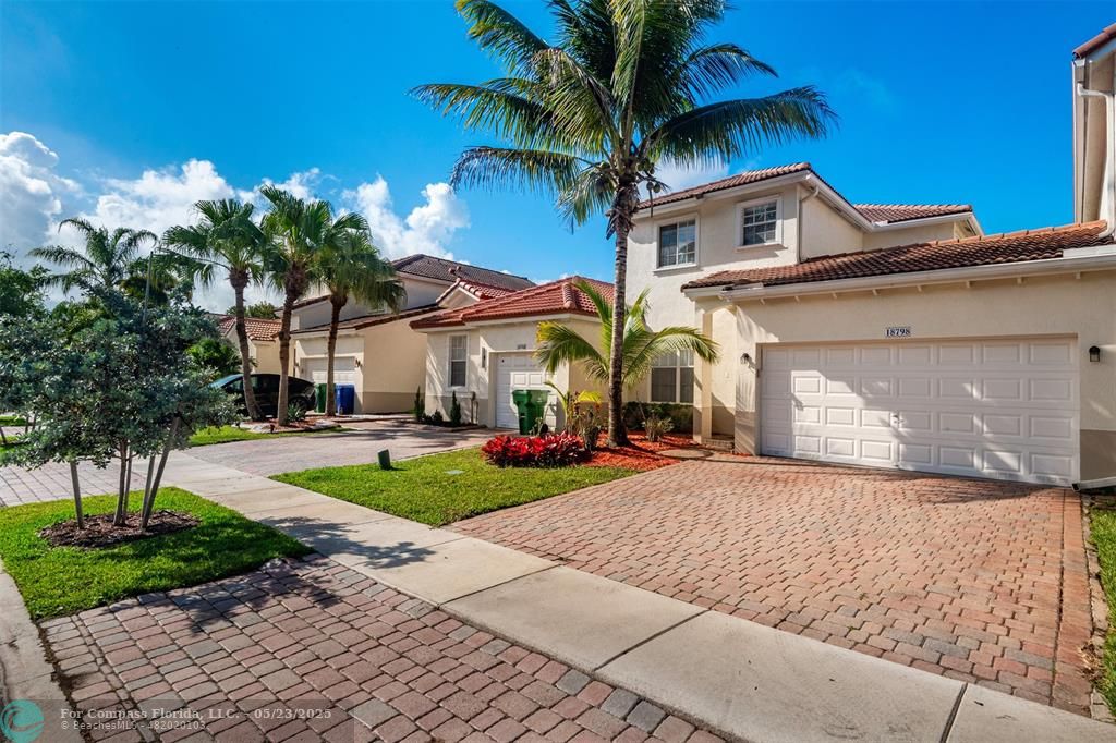 18798 Southwest 28th Street, Unit 18798 Miramar, FL 33029 - Photo 2 of 28 a front view of a house with garden