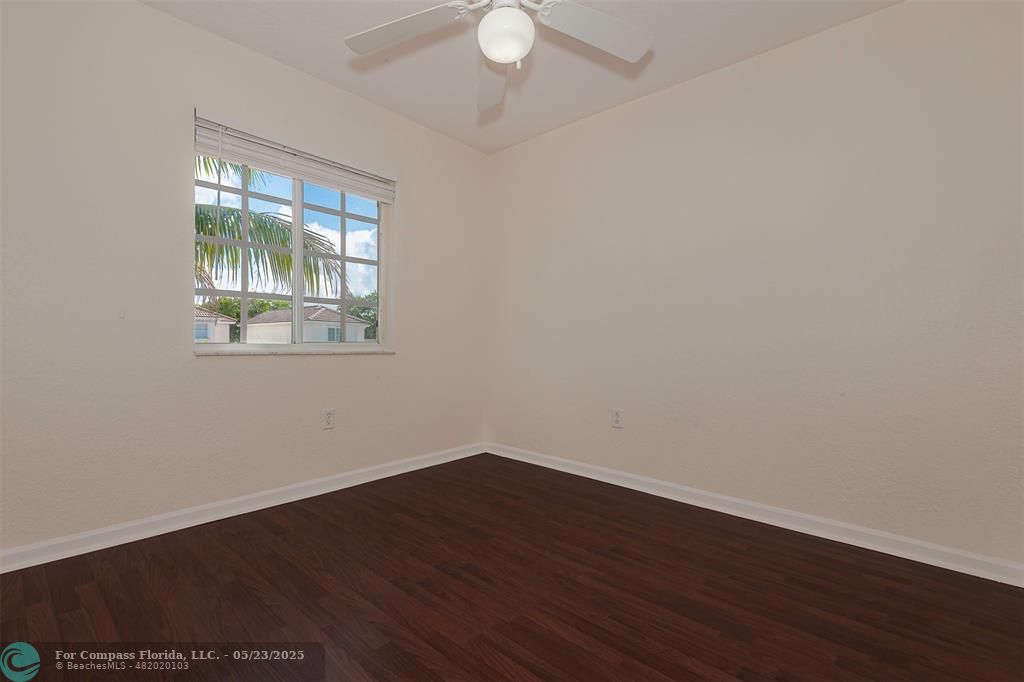 18798 Southwest 28th Street, Unit 18798 Miramar, FL 33029 - Photo 22 of 28 a view of an empty room with wooden floor and a window