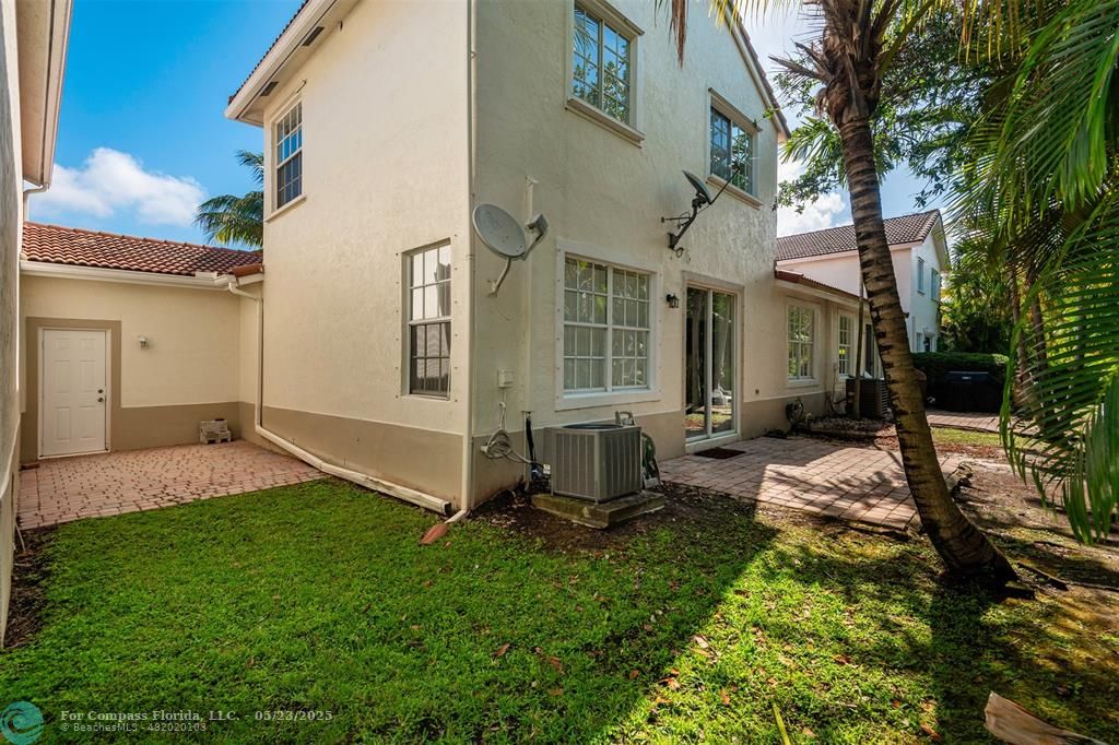 18798 Southwest 28th Street, Unit 18798 Miramar, FL 33029 - Photo 28 of 28 a backyard of a house with table and chairs