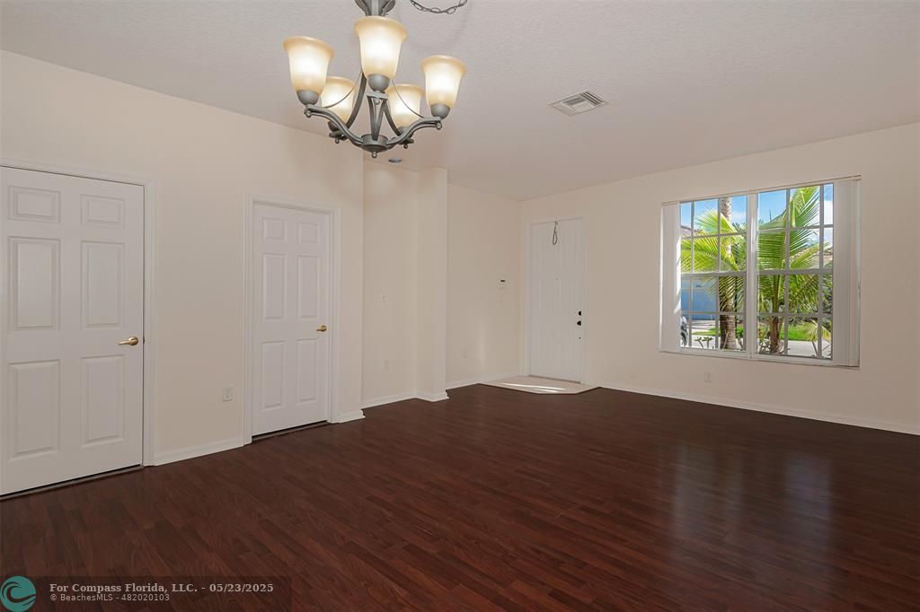 18798 Southwest 28th Street, Unit 18798 Miramar, FL 33029 - Photo 5 of 28 a view of empty room with wooden floor and fan