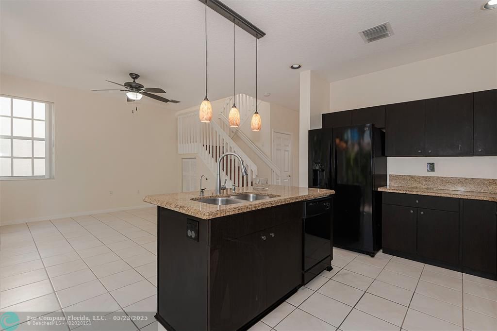 18798 Southwest 28th Street, Unit 18798 Miramar, FL 33029 - Photo 10 of 28 a kitchen with a sink a refrigerator and cabinets