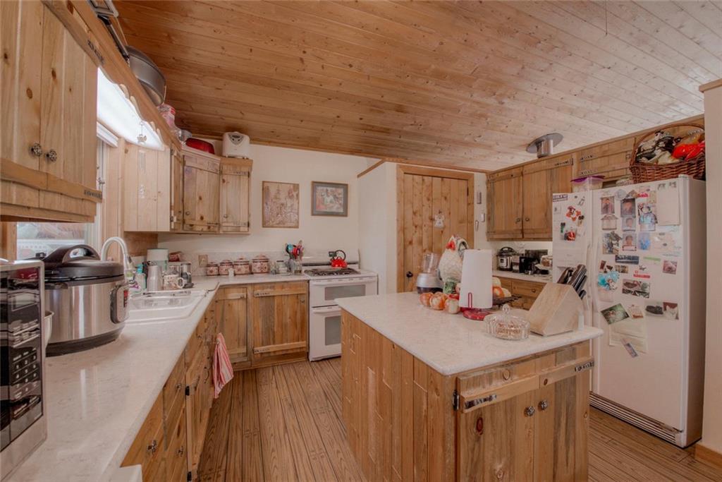 468 Wagon Wheel Road Hartsel, CO 80449 - Photo 14 of 30 a kitchen with a sink refrigerator and cabinets