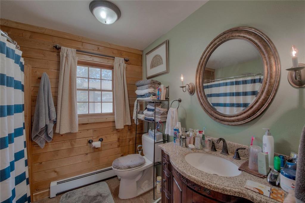 468 Wagon Wheel Road Hartsel, CO 80449 - Photo 18 of 30 a bathroom with a granite countertop toilet a sink and a mirror