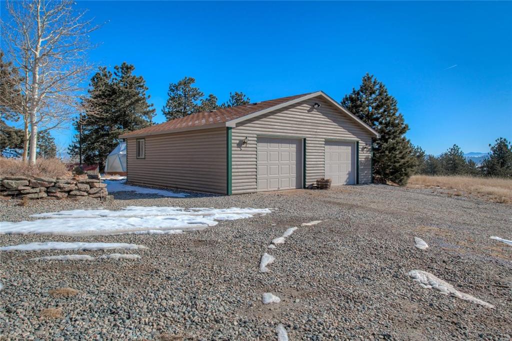 468 Wagon Wheel Road Hartsel, CO 80449 - Photo 3 of 30 a view of a house with a yard and garage