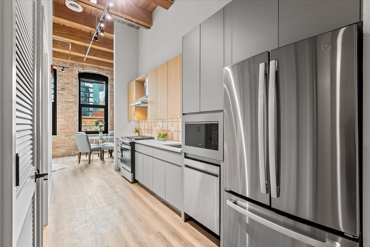 153 West Ohio Street, Unit 403 Chicago, IL 60654 - Photo 6 of 15 a kitchen with stainless steel appliances a refrigerator and a stove top oven