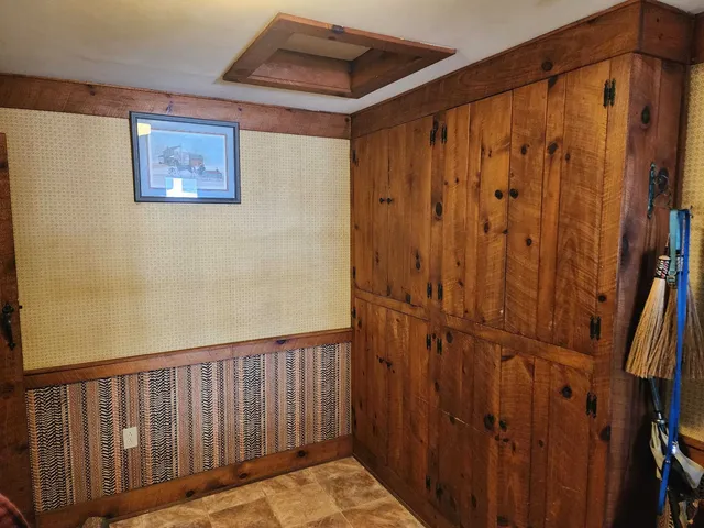 a view of a hallway with wooden walls