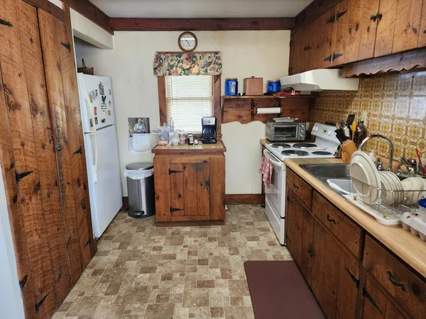 a kitchen with refrigerator and cabinets