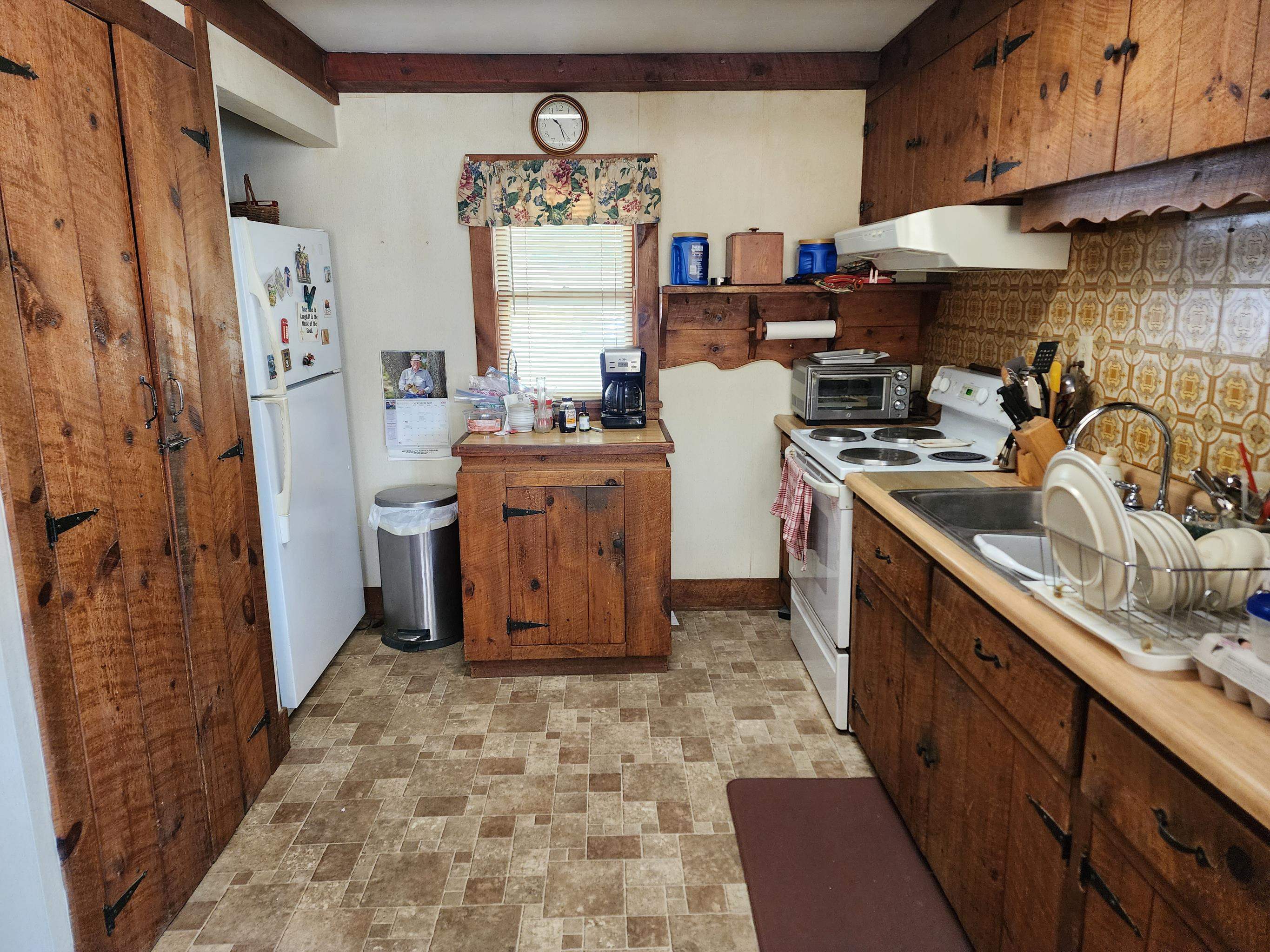 11611 Cowpasture River Road Williamsville, VA 24487 - Photo 15 of 29 a kitchen with refrigerator and cabinets