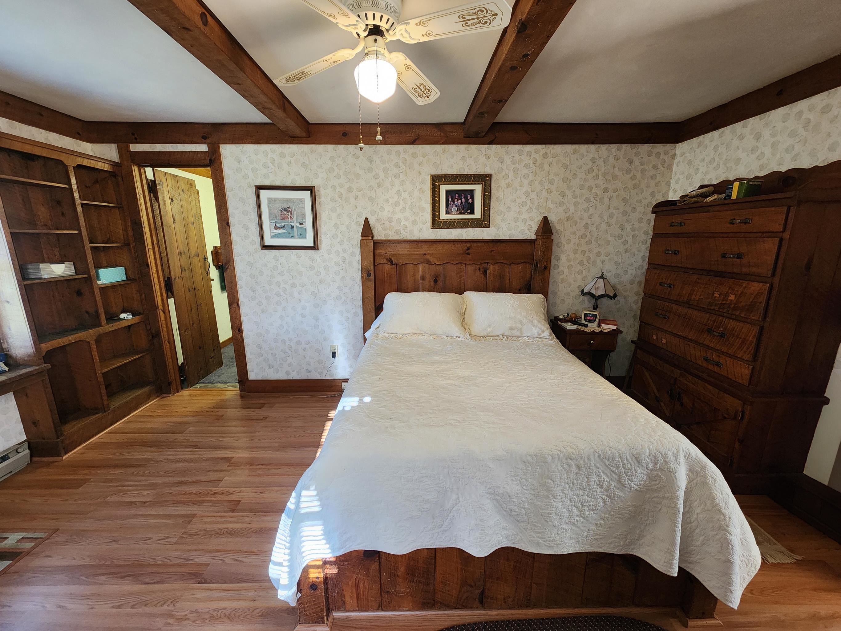 11611 Cowpasture River Road Williamsville, VA 24487 - Photo 16 of 29 a bedroom with a bed and a flat tv screen