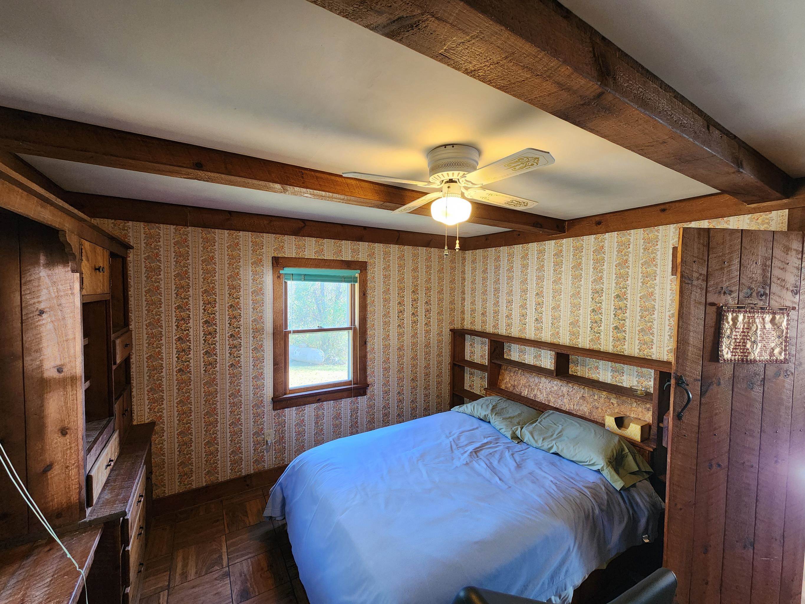11611 Cowpasture River Road Williamsville, VA 24487 - Photo 20 of 29 a bedroom with a bed and a flat tv screen on dresser