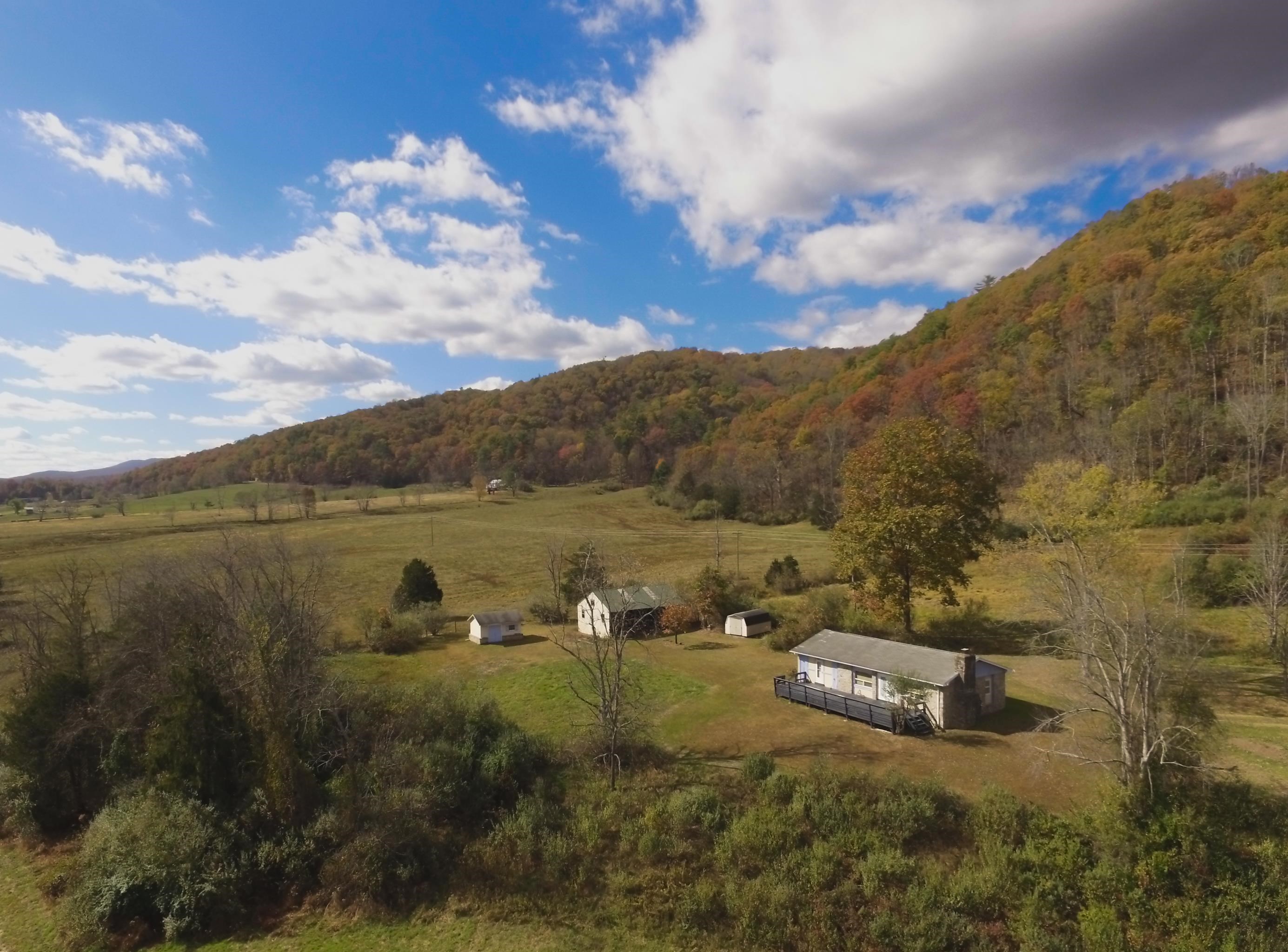 11611 Cowpasture River Road Williamsville, VA 24487 - Photo 2 of 29 a view of a town with mountains in the background