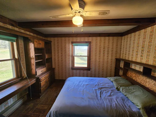 a bedroom with a bed and a television