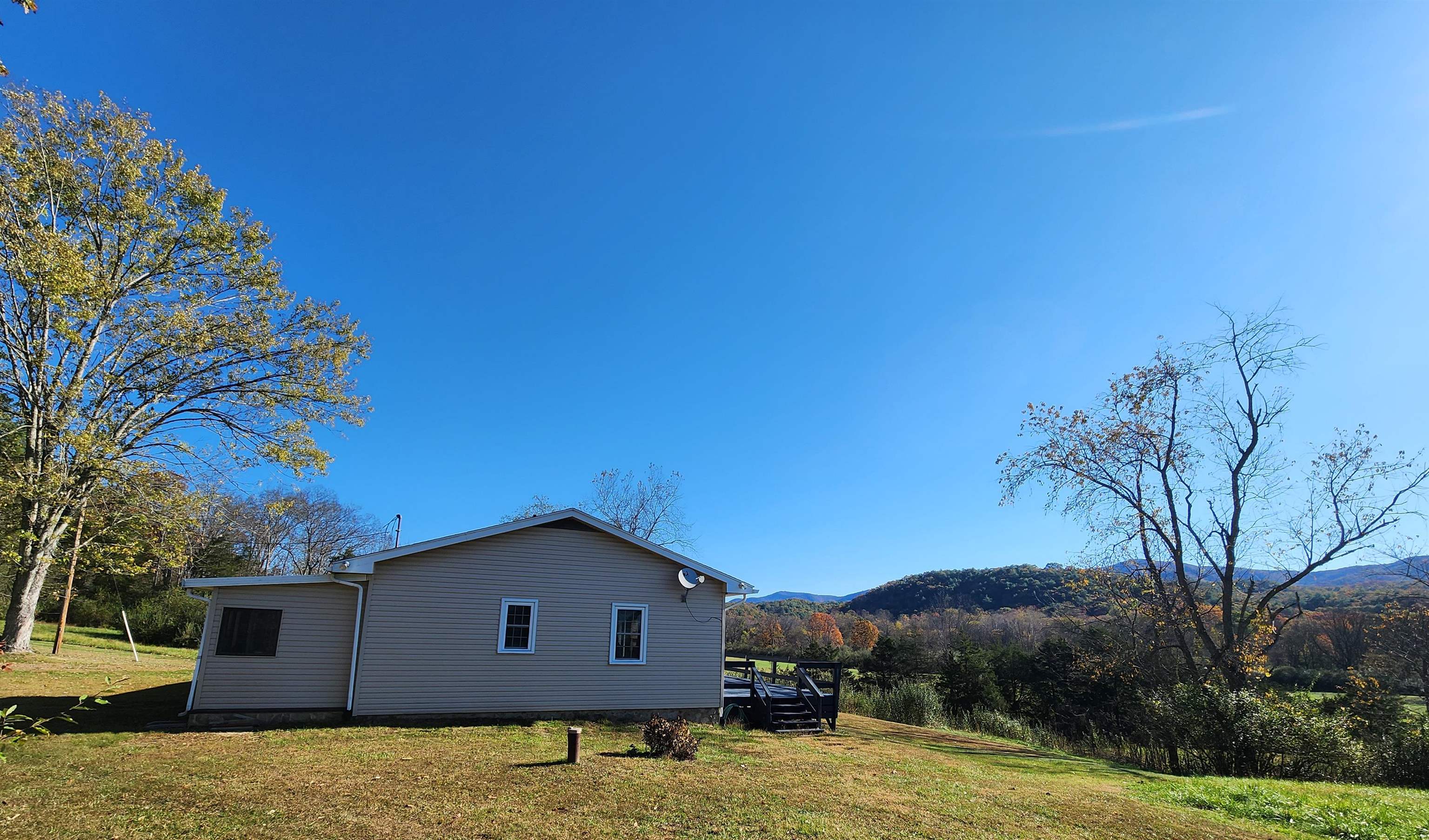 11611 Cowpasture River Road Williamsville, VA 24487 - Photo 5 of 29 a house with trees in the background