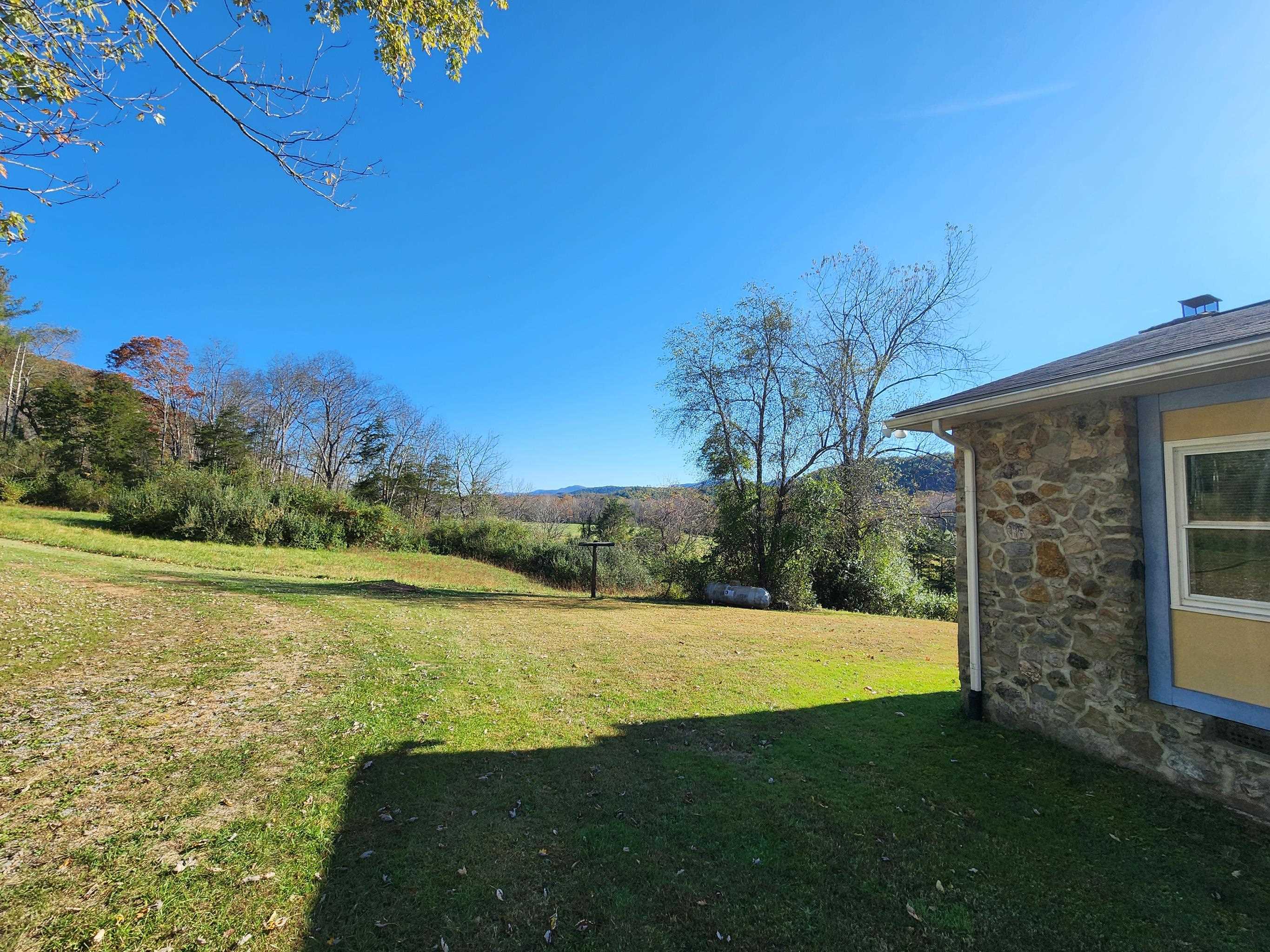 11611 Cowpasture River Road Williamsville, VA 24487 - Photo 10 of 29 a view of a backyard with a garden