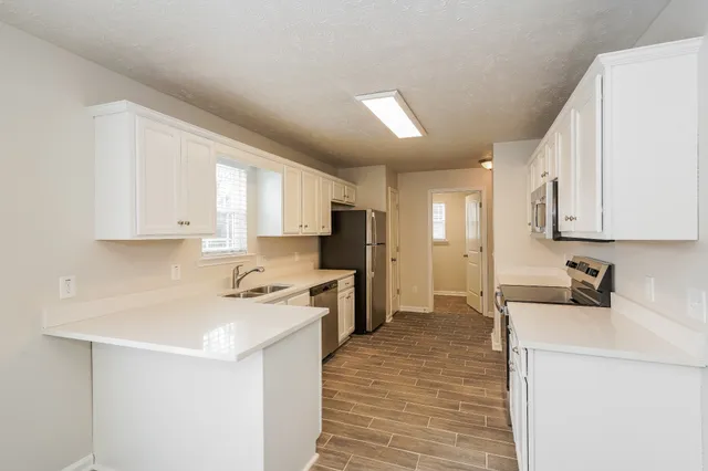a kitchen with a sink a stove and refrigerator