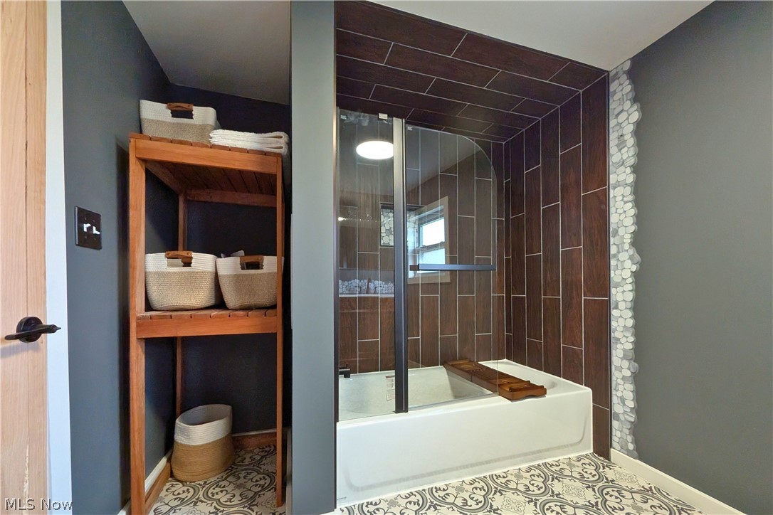 12972 Gilmore Road Southeast Port Washington, OH 43837 - Photo 25 of 50 Bathroom with enclosed tub / shower combo and baseboards