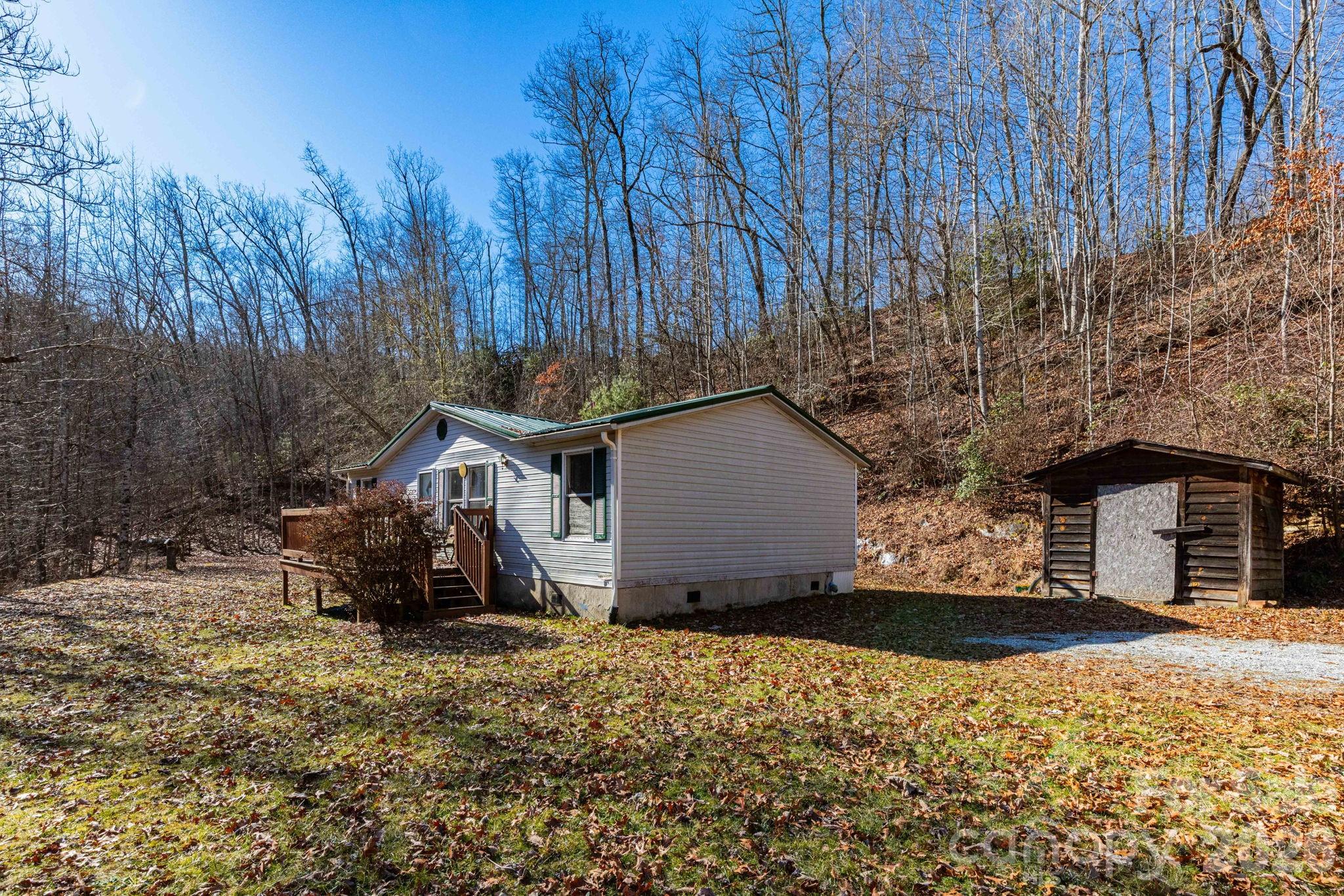 143 Hubert McCall Drive Balsam Grove, NC 28708 - Photo 14 of 21 a view of a house with a yard