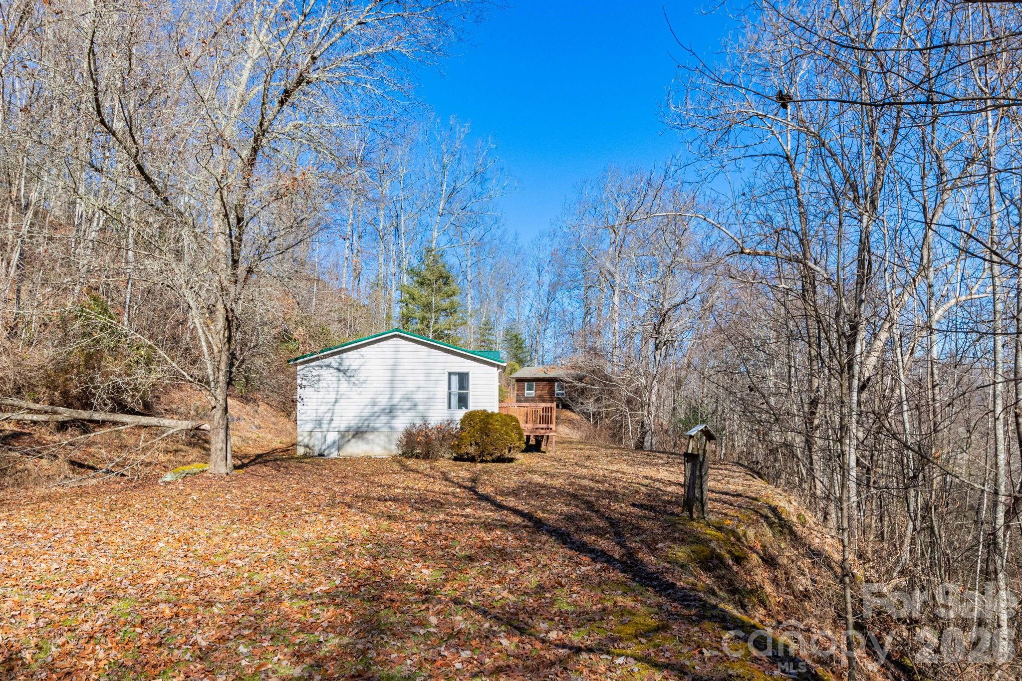 143 Hubert McCall Drive Balsam Grove, NC 28708 - Photo 16 of 21 a backyard of a house with a large tree