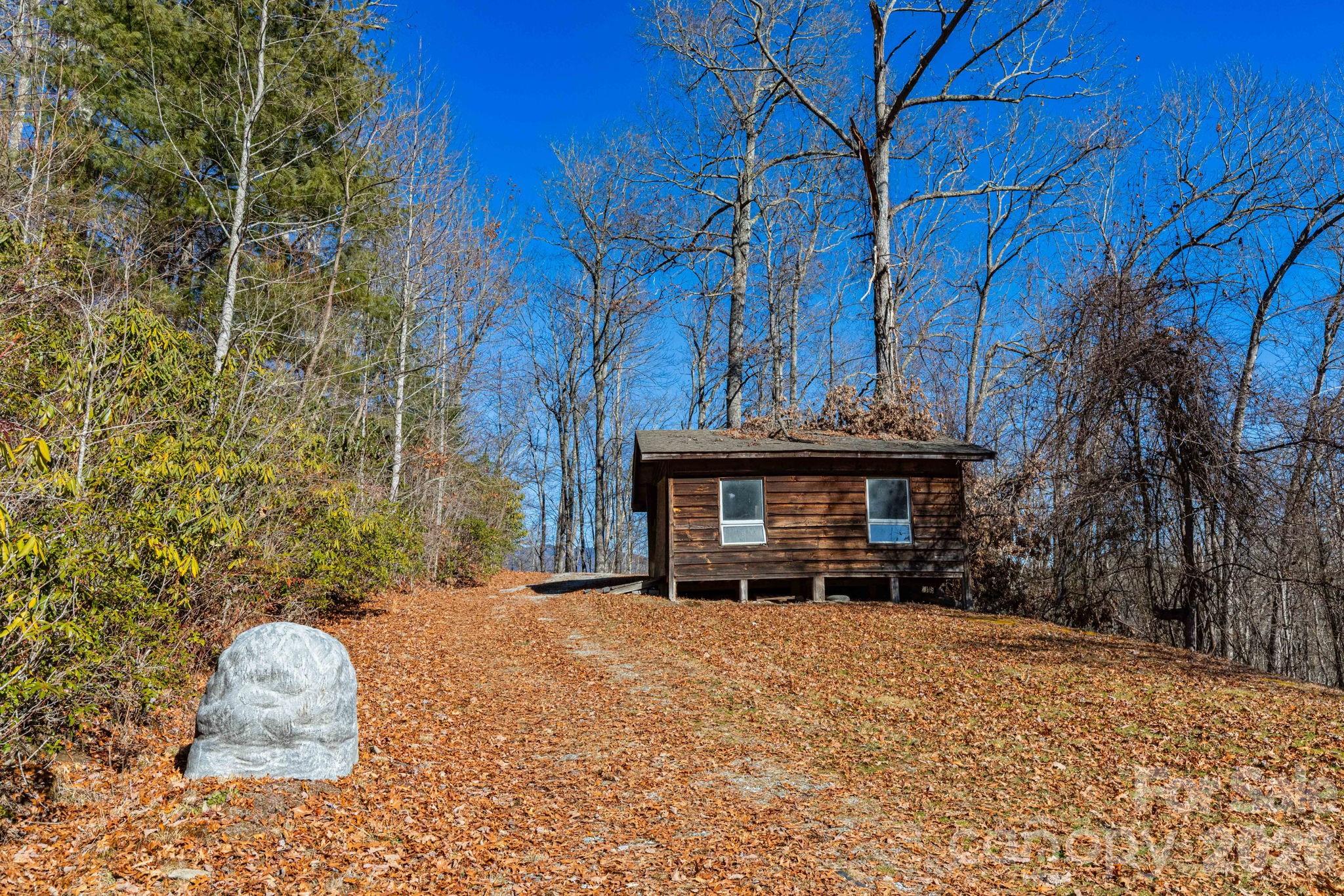 143 Hubert McCall Drive Balsam Grove, NC 28708 - Photo 18 of 21 a view of a house with a yard