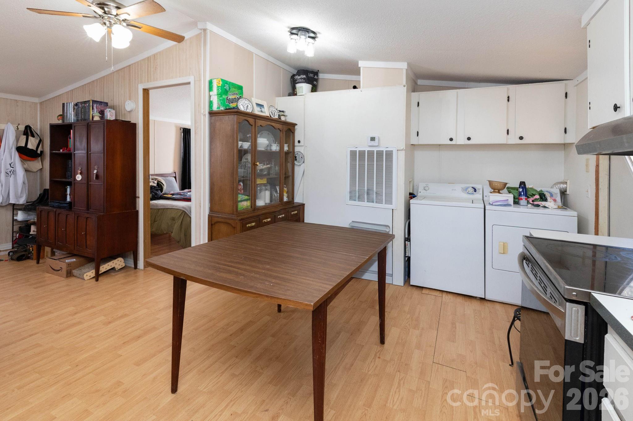 143 Hubert McCall Drive Balsam Grove, NC 28708 - Photo 8 of 21 a kitchen with a table chairs refrigerator and microwave