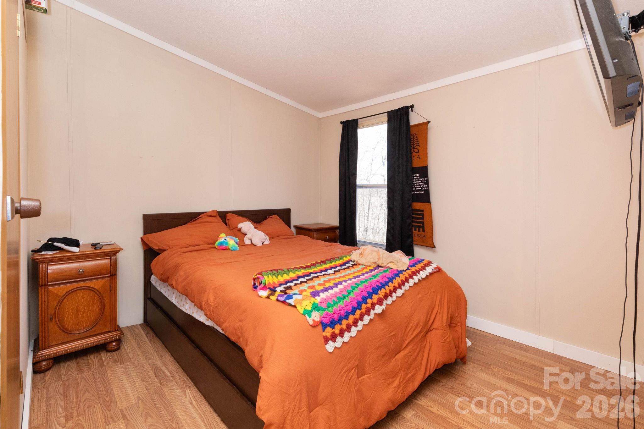 143 Hubert McCall Drive Balsam Grove, NC 28708 - Photo 10 of 21 a bedroom with a bed and a window