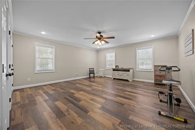 a view of a livingroom with a hardwood floor and a ceiling fan