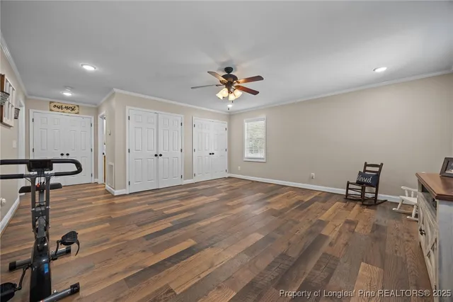 a living room with furniture and a ceiling fan